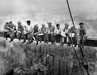 Lunch for workers atop a steel beam 800 feet above ground, during construction of the RCA Building in Rockefeller Center, New York